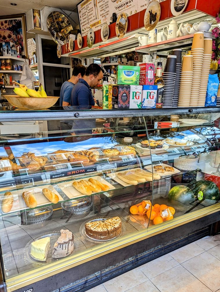Tarts, cakes and croissants in the glass display case
