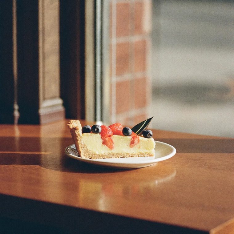 A slice of fruit tart on a white plate